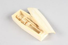 A BONE COFFIN AND SKELETON. 4.5ins long.