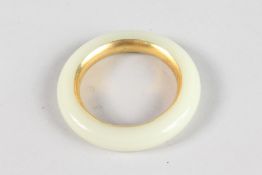 A CHINESE WHITE JADE AND GILT BANGLE. 3.5ins diameter.