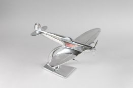 A CHROME TABLE MODEL OF A SPITFIRE. 12ins long.