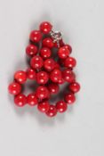 A STRING OF CORAL BEADS.