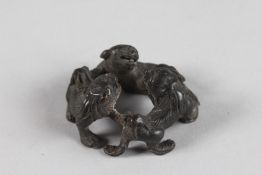 THREE BRONZE FOO DOGS. 2.25ins diameter.