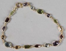 AN 18CT YELLOW GOLD AND MULTI-GEM SET BRACELET.