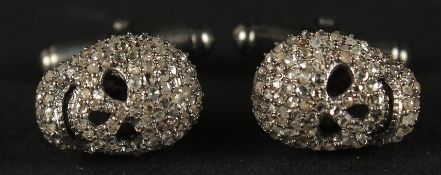 A PAIR OF R/C DIAMOND SET SKULL CUFFLINKS in white metal, boxed. Diamonds 1.55ct.