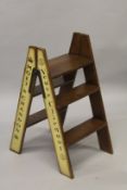 A SET OF DOM PERIGNON, BOLLINGER, MOET AND VEUVE PAINTED WOODEN FOLDING LADDERS.