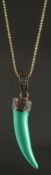 A TURQUOISE ENAMEL TIGER TOOTH PENDANT set to the top with old rose-cut diamonds, in yellow metal on