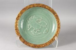 A CHINESE CELADON GLAZE KYLIN DISH. 27cms diameter.