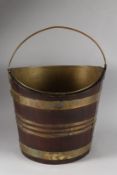 A GEORGIAN MAHOGANY BRASS BOUND BUCKET with metal liner and handle. 14ins high.