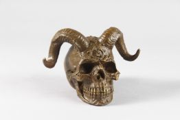 A BRONZE SKULL with horns. 4.5ins high.