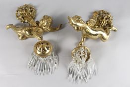 A GOOD PAIR OF GILT BRONZE CUPID LIGHTS with glass drop. 12ins.