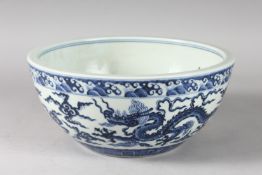 A CHINESE BLUE AND WHITE PORCELAIN DRAGON BOWL. 26.5cms diameter.