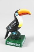 A PAINTED CAST IRON TOUCAN GUINNESS SIGN. 6ins high.