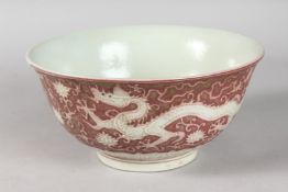 A CHINESE UNDERGLAZE RED PORCELAIN DRAGON BOWL. 21.5cms diameter.