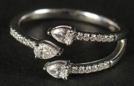 A 10CT WHITE GOLD (TESTED AS 9CT) TRIDENT-STYLE DIAMOND RING. Pear-cut and RBC diamonds 0.40ct
