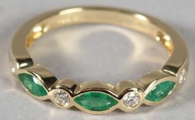 AN 18CT YELLOW GOLD, EMERALD AND DIAMOND MARQUISE HALF ETERNITY RING.