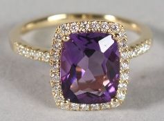 AN 18CT YELLOW GOLD, AMETHYST AND DIAMOND CLUSTER RING.