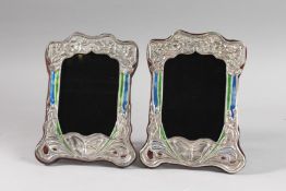 A PAIR OF SILVER AND ENAMEL BUTTERFLY PHOTOGRAPH FRAMES.