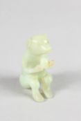 A CHINESE CARVED JADE MONKEY.