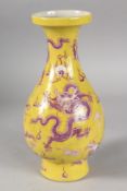 A CHINESE YELLOW GROUND PORCELAIN DRAGON VASE. 27.5cms high.