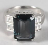 A SILVER LONDON BLUE TOPAZ ART DECO STYLE RING.