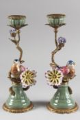 A PAIR OF PORCELAIN AND METAL BIRD CANDLESTICKS. 12ins high.