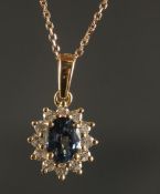 AN 18CT YELLOW GOLD OVAL SAPPHIRE AND RBC DIAMOND CLUSTER NECKLACE, boxed. Sapphire 0.75ct. Diamonds