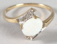 A 9CT GOLD OPAL AND DIAMOND RING.