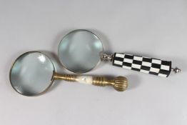 A MAGNIFYING GLASS with mother-of-pearl and metal handles.