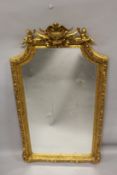 A GOOD LOUIS XVITH STYLE GILTWOOD GILDED UPRIGHT MIRROR with acanthus, shells and cupids. 5ft 9ins