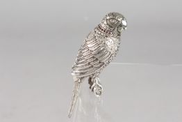 A SILVER PLATED PARROT SCENT BOTTLE with a ruby collar.