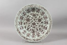 A LARGE CHINESE UNDERGLAZE RED AND WHITE PORCELAIN PETAL-RIM DISH, with decorative floral motifs,