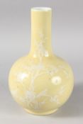 A CHINESE YELLOW GLAZE PORCELAIN BOTTLE VASE, decorated with white enamelled tree and birds, the