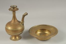 A 17TH CENTURY MUGHAL INDIAN BRASS OR BRONZE EWER AND BASIN, ewer 24cm high, (2).
