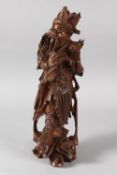 A CHINESE CARVED HARDWOOD WARRIOR FIGURE, with multiple inset eyes, 39cm high.