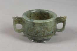 A FINE CHINESE CARVED JADE TWIN HANDLE CENSER, with archaic designs, applied collection sticker to