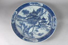 A LARGE 19TH CENTURY CHINESE BLUE AND WHITE PORCELAIN CHARGER, painted with a landscape scene
