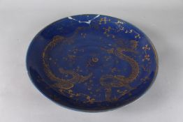 A CHINESE BLUE GLAZED GILT DRAGON CHARGER, the base with six-character mark in red, (af), 36cm