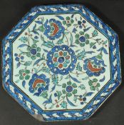 AN ISLAMIC MARKET FRENCH OR ITALIAN GLAZED POTTERY OCTAGONAL TILE, painted with floral motifs,