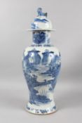 A LARGE CHINESE BLUE AND WHITE PORCELAIN BALUSTER VASE AND COVER, painted with a mountainous