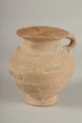 A 10TH CENTURY MIDDLE EASTERN ISLAMIC UNGLAZED POTTERY JUG, with carved calligraphy and animals,