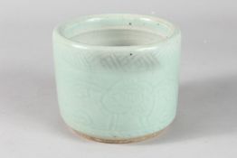 AN EARLY CHINESE CELADON GLAZE POTTERY BRUSH POT, 10.5cm high.