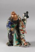 A 19TH CENTURY JAPANESE KUTANI PORCELAIN FIGURAL GROUP, 25.5cm high.