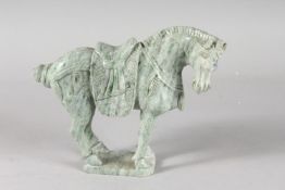 A CARVED GREEN HARDSTONE FIGURE OF A HORSE, 17cm high, 21cm long.