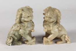 A PAIR OF CHINESE CARVED GREEN SOAPSTONE TEMPLE LIONS, 12cm high.