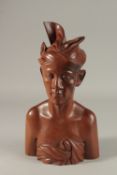 A FINELY CARVED BALINESE BUST OF A MAN, 34cm high.
