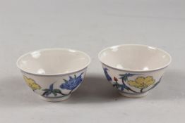 A PAIR OF CHINESE DOUCAI PORCELAIN TEA BOWLS, with floral decoration, each base with six-character
