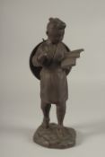 A FINE JAPANESE BRONZE OKIMONO OF A BOY HOLDING A BOOK, signed to the reverse, 31cm high.