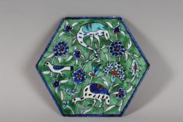 AN EARLY 20TH CENTURY PALISTIAN ARMENIAN HEXAGOAL POTTERY TILE, depicting birds and folate motifs,