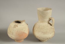 TWO 12TH-13TH CENTURY SELJUK ANATOLIAN UNGLAZED POTTERY JUGS, one signed, made by Rafi, largest 22cm