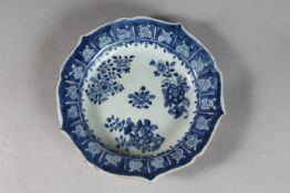 AN 18TH-19TH CENTURY CHINESE BLUE AND WHITE PORCELAIN DISH, with petal form rim and painted with