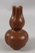 A CHINESE CHESTNUT-BROWN GLAZE PORCELAIN THREE-NECK TULIP VASE, character mark to base, 22cm high.